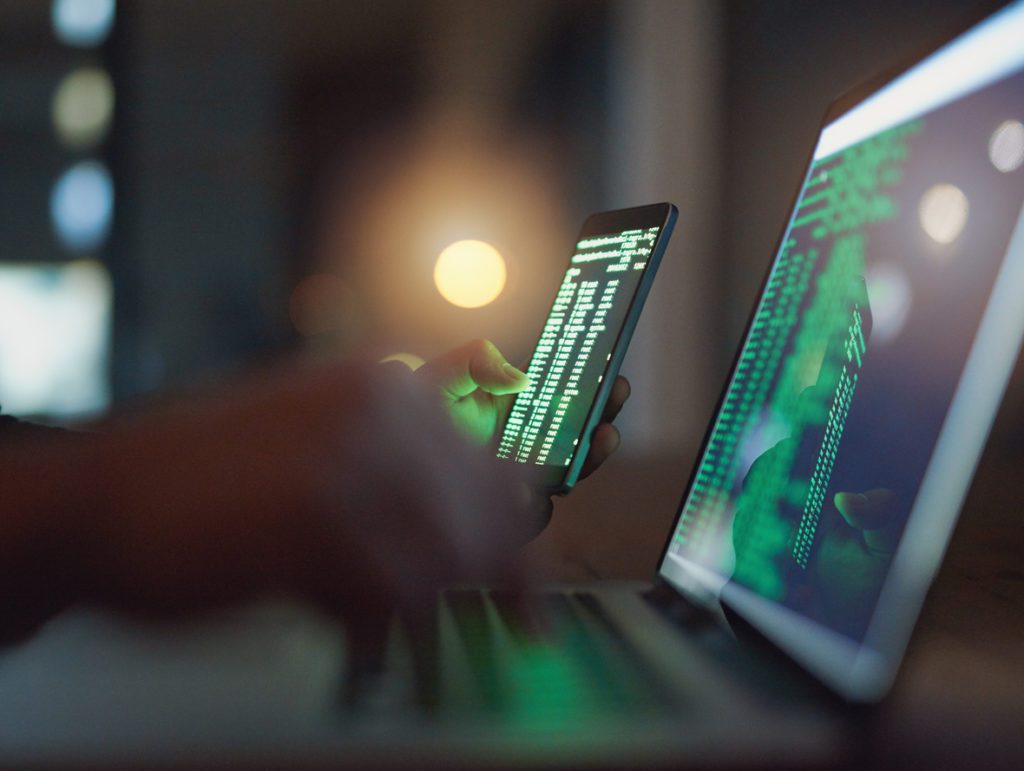 Hacker in the dark using computer for hacks in 2018