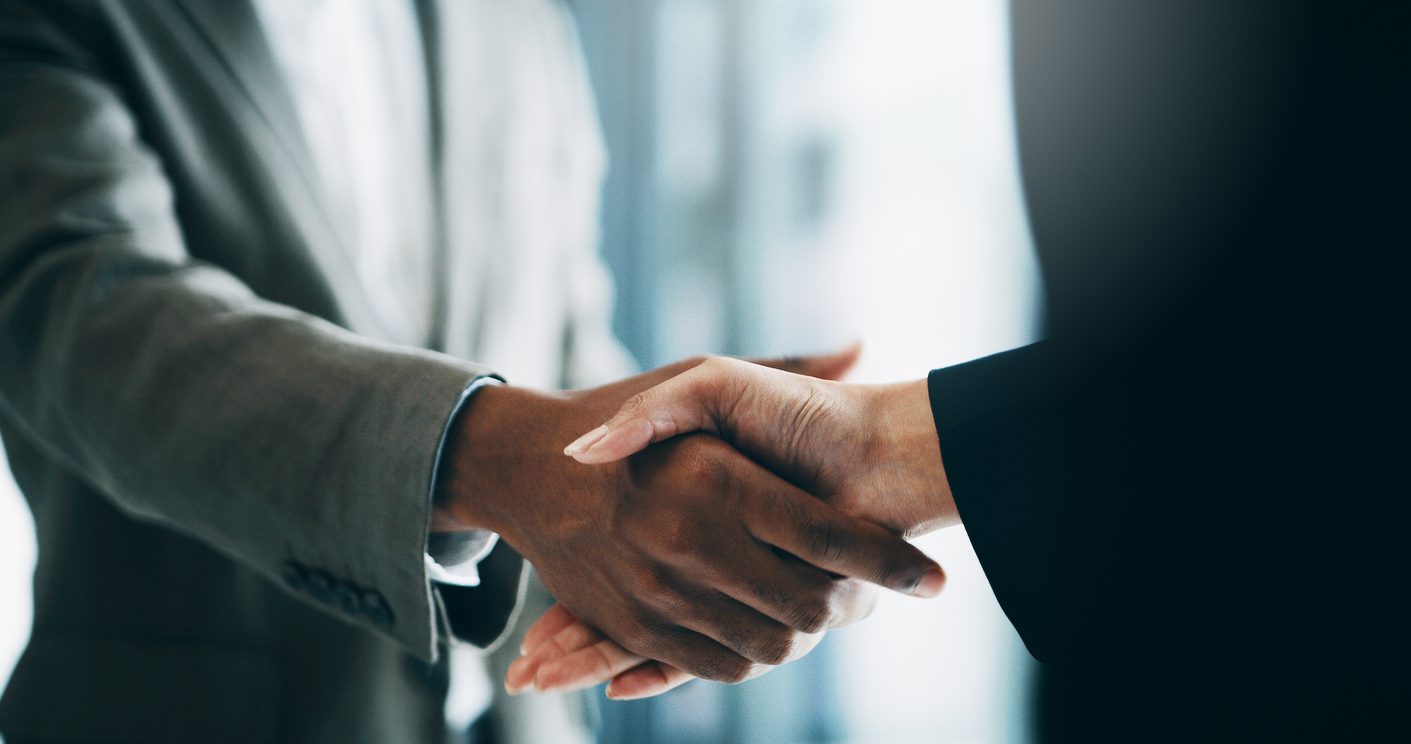 shaking hands after all it due diligence is complete for m&a.
