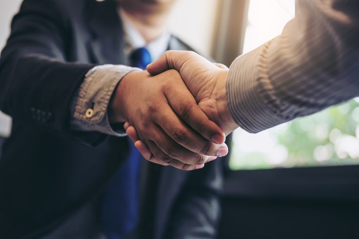 two-businessmen-shaking-hands-during-a-meeting-contractors-concept